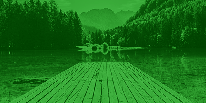 a wooden dock streching out on a mountain lake
