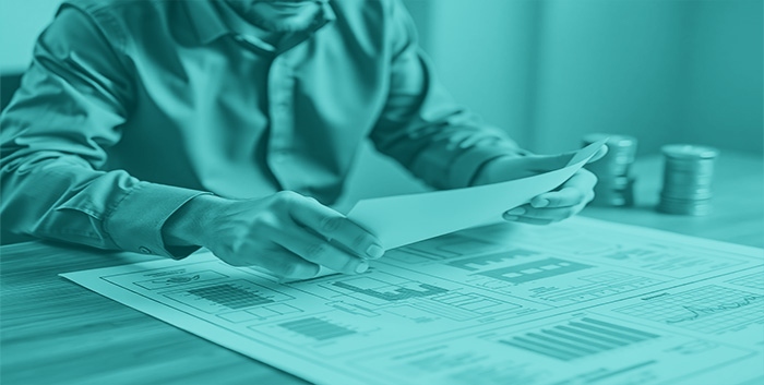 "person designing a blueprint of a financial plan, symbolizing strategic financial planning and confidence."